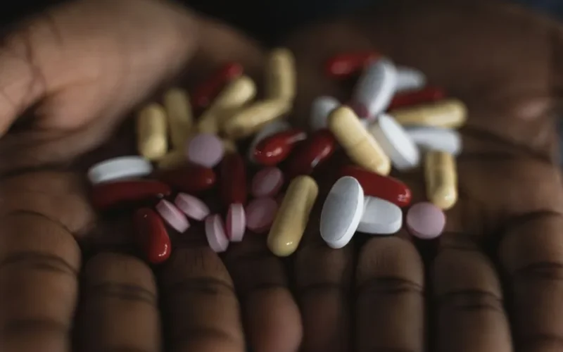 A variety of medications, including pills and capsules, held in open hands. Perfect for health-related content.