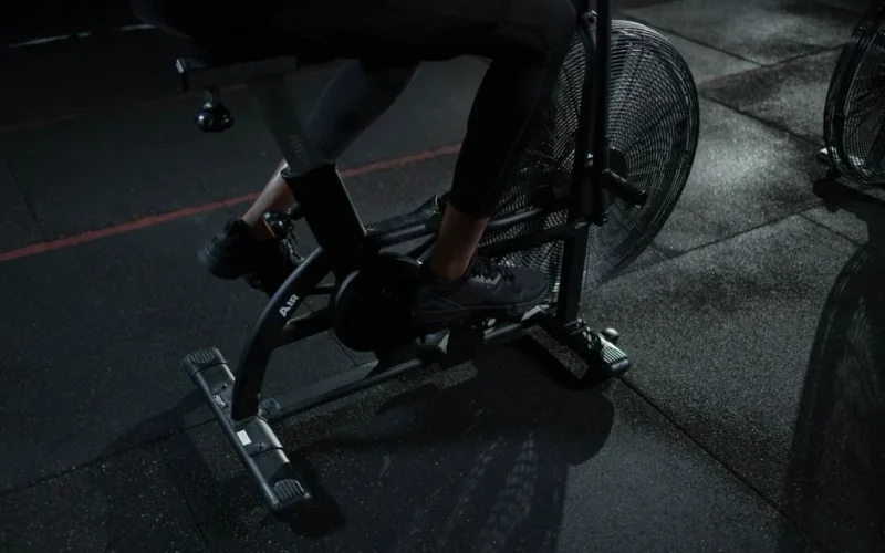 Focused indoor workout on exercise bike showcasing active lifestyle and fitness training.