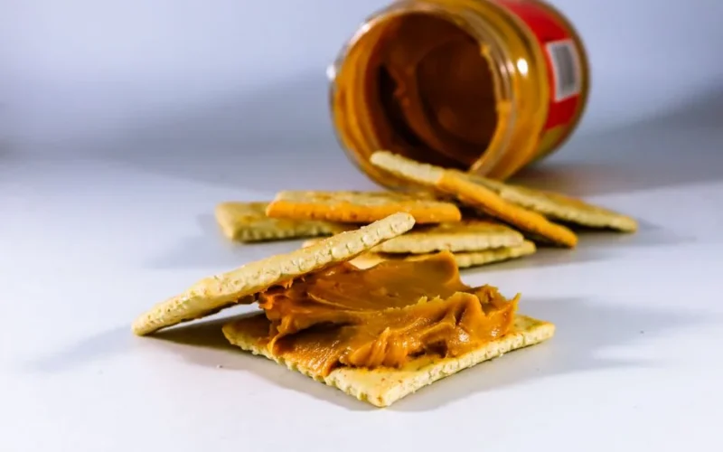 Delicious peanut butter spread on crispy crackers, perfect for a tasty snack.