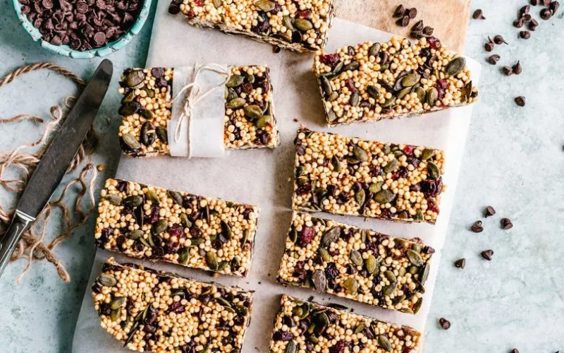 Top view of homemade granola bars with seeds and chocolate chips.
