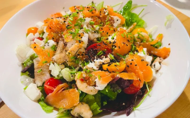 Colorful seafood salad with smoked salmon, prawns, and fresh vegetables perfect for a nutritious meal.