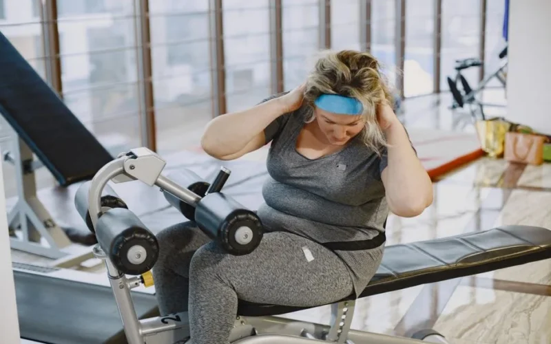 A woman working out on gym equipment, promoting fitness and a healthy lifestyle.
