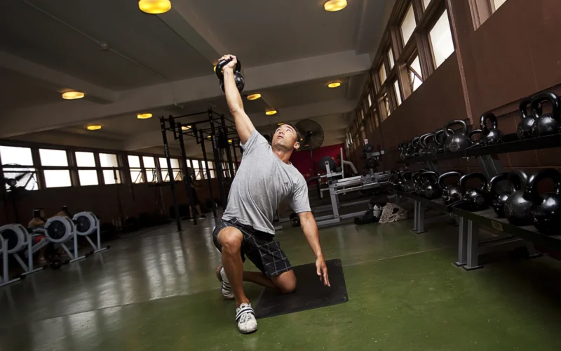 Navy Lieutenant Cmdr. Andy Silvestri, a dentist with 21st Dental Company and 35-year-old from San Jose, Calif., performs Turkish get-ups during a circuit workout at the High Intensity Tactical Training (HITT) Center on Marine Corps Base Hawaii, Aug. 14, 2012. Open since August 2011, the HITT Center is a gym devoted to supporting circuit and high-intensity cross training. Equipment featured inside includes battle ropes, BOSU and Dyna balls, ellipticals, kettle bells, medicine balls, plyometric boxes, rowing machines and TRX suspension training rings. The center, located in Building 1034 next to the 3rd Marine Regiment Satellite Fitness Center, is available for use by service members Monday through Friday, from 6 a.m. to 9 p.m.