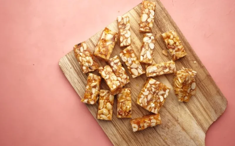 Wooden cutting board displaying tasty homemade nut bars, ready to eat.