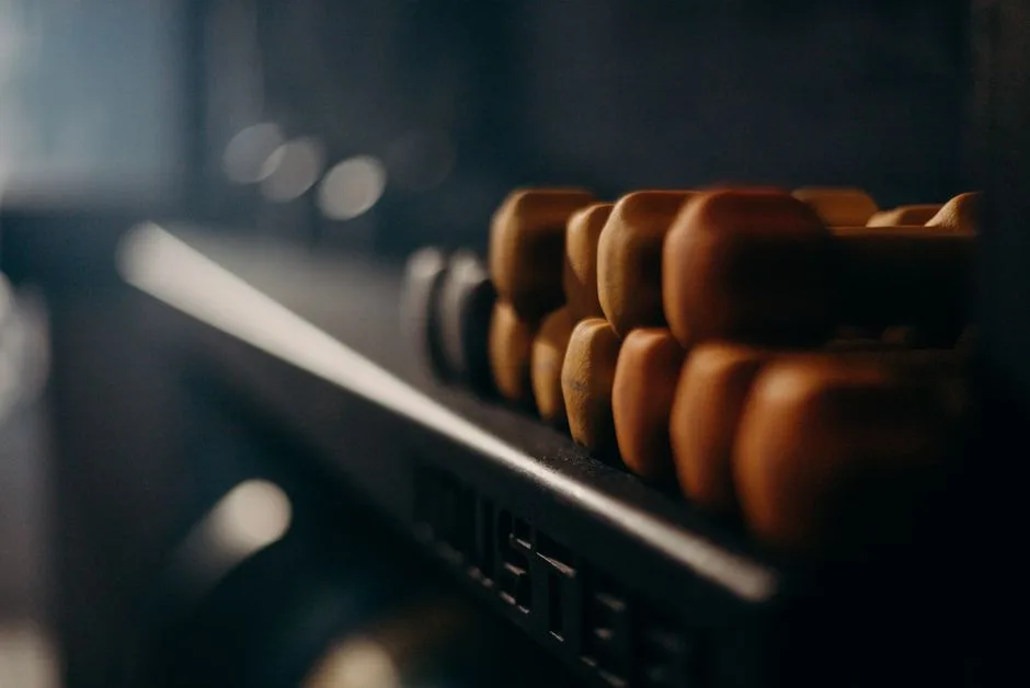 A rack of dumbbells in a dimly lit gym, highlighting fitness equipment.