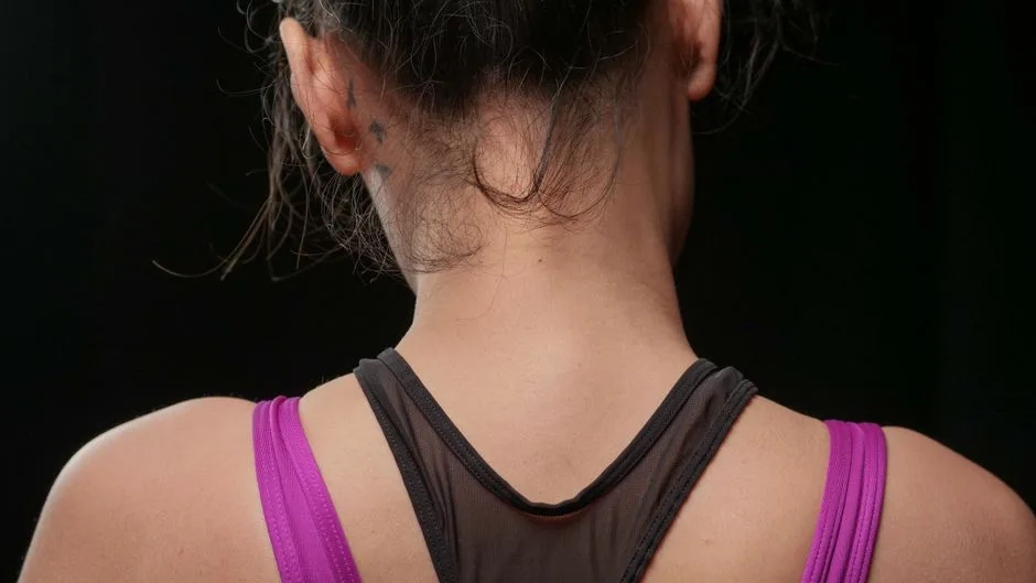 Close-up view of a woman's back wearing a sports tank top. Ideal for fitness and lifestyle themes.