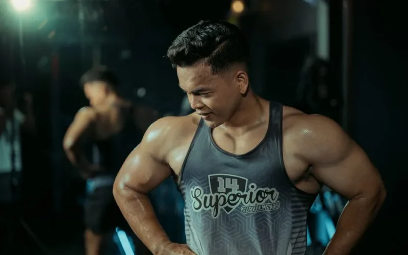 Muscular man in gym showing strength and determination.